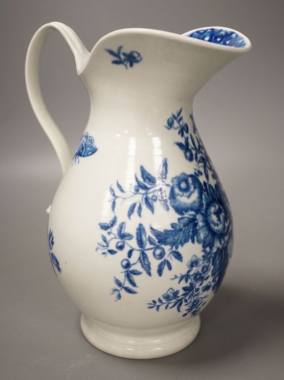 A Worcester French style water ewer decorated in under-glaze blue with fir cones and rose hips c. 1775, 21cm